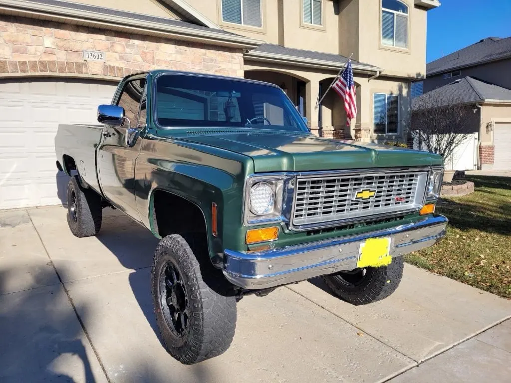 Classic green Chevrolet pickup truck with tinted windshield