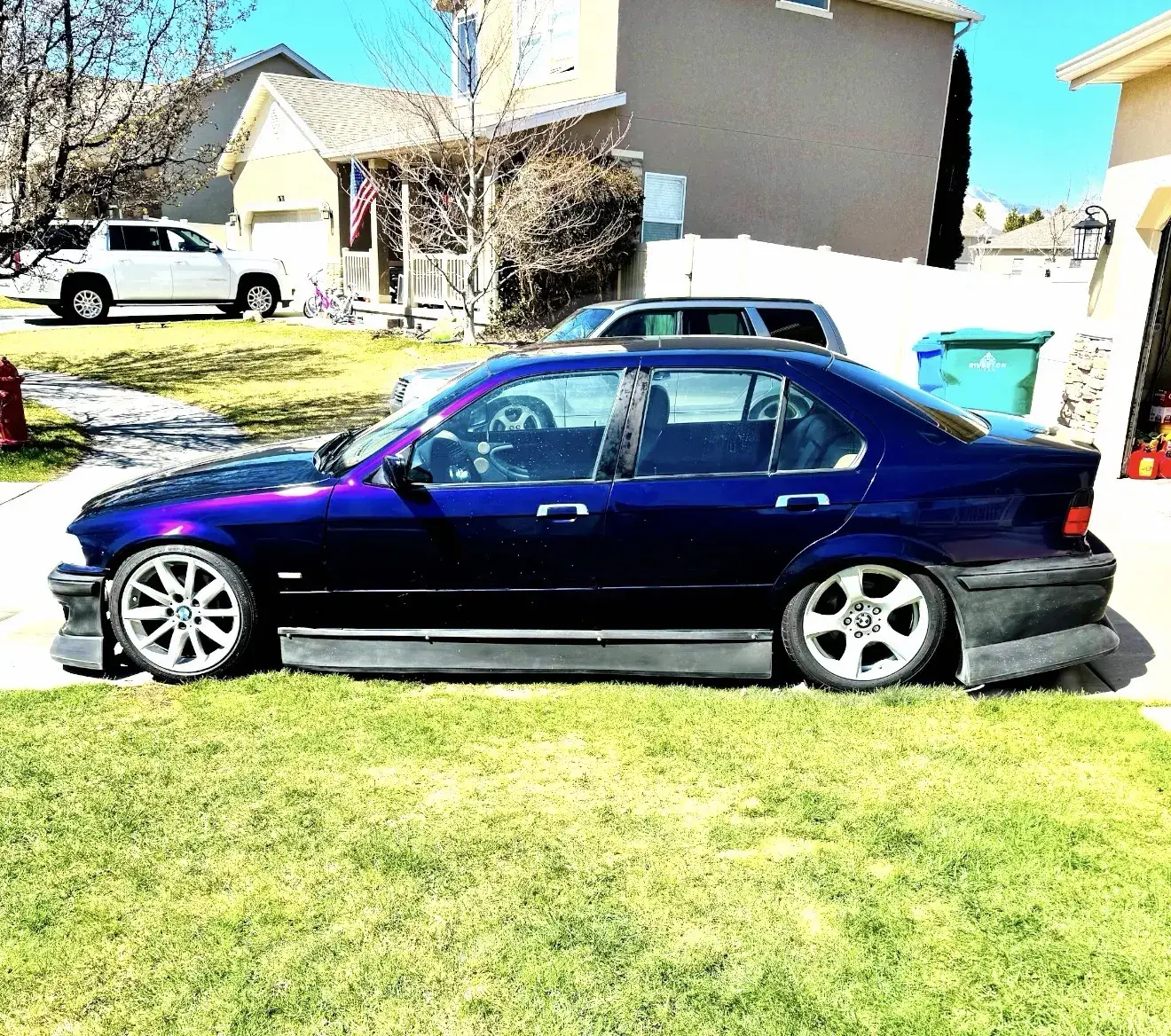 Same BMW 3 Series finished with a purple-blue color-shift vinyl wrap