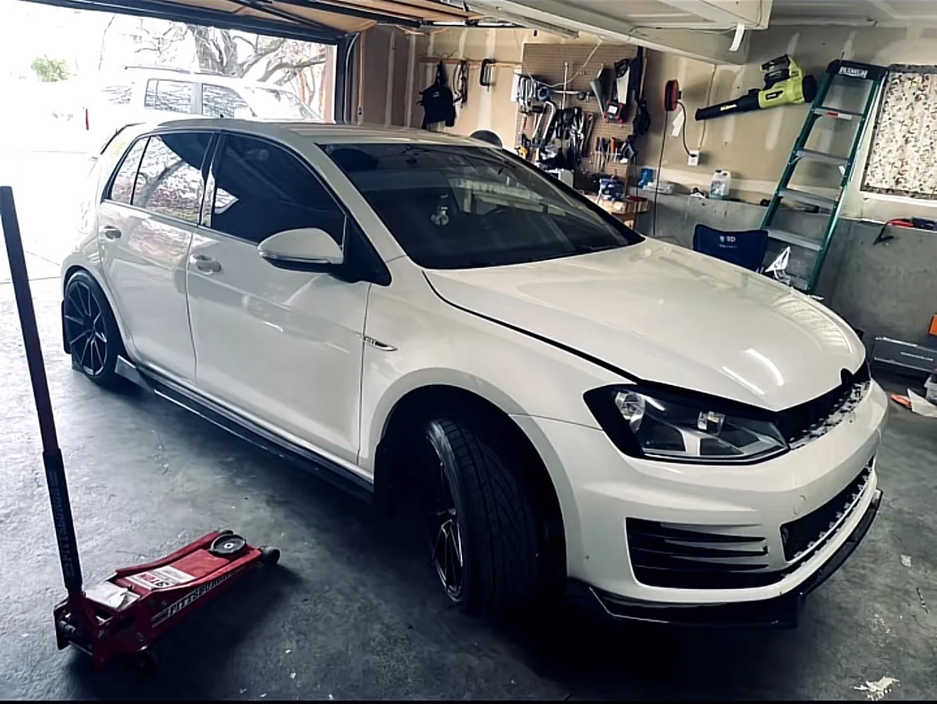 White Volkswagen GTI before a custom color-shift wrap